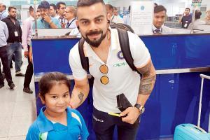 Indian captain Virat Kohli clicks picture with a young fan