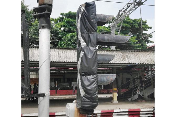 An indicator and a signal covered with plastic sheets at railway stations