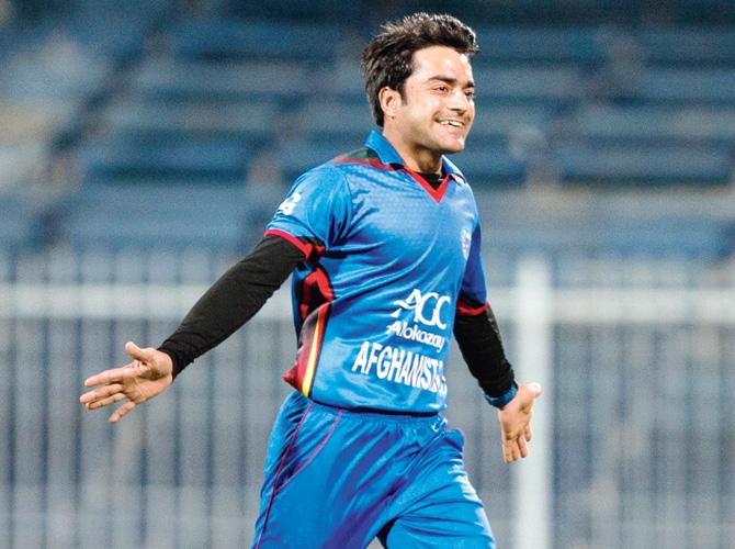 Afghan spinner Rashid Khan celebrates the wicket of Ireland