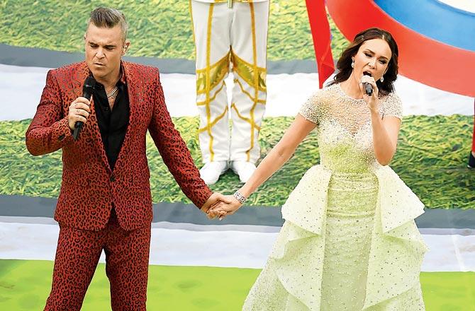 Singers Robbie Williams (left) and Aida Garifullina perform during the FIFAâu00c2u0080u00c2u0088World Cup opening ceremony yesterday. Pic/Getty Images