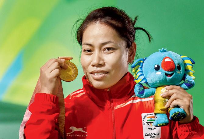 Sanjita Chanu with her gold medal after winning the women