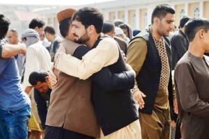 Taliban and Afghan forces embrace at Eid