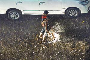Mumbai: Young boys make a splash during Monday showers at Sion