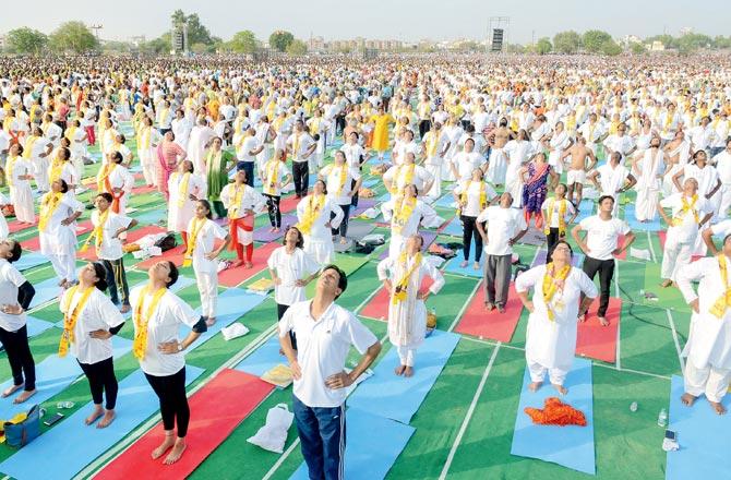 Yoga enthusiasts perform during an event by Baba Ramdev and Rajasthan Chief Minister Vasundhara Raje to set the Guinness World Record for 