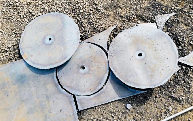 The salvage team are using metal plates to seal openings on the ship