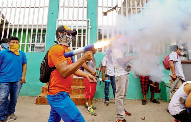 A masked protester shoots off his homemade mortar in Masaya on Saturday. Pic/AFP