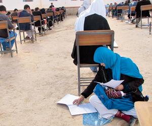 Powerful photo! Afghan mom gives university exams with baby on her lap