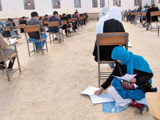 The picture has sparked an outpouring of admiration and offers of financial help for Jahantab Ahmadi, mother of three. Pics/AFP