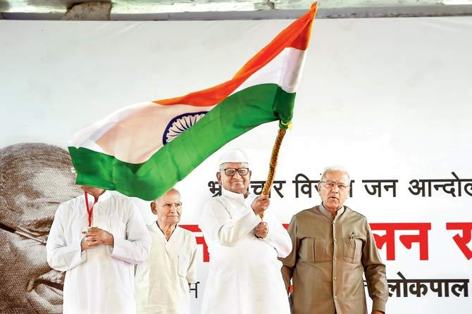 Indian social activist Anna Hazare waves the national flag during a protest against the government in New Delhi on Friday. PIC/AFP