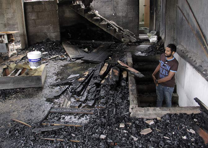 A man looks at a burnt home a day after anti-muslim riots erupted in Digana, a suburb of Kandy. Pic/AFP