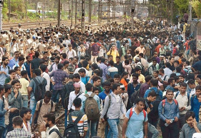 Protestors, cops and stranded commuters crowd the tracks between Dadar and Matunga stations on the Central Railway line. Both cops and protestors got injured in the clash.