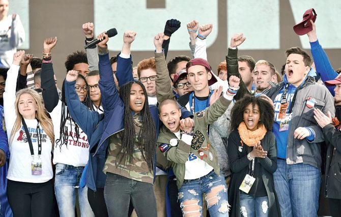 Marjory Stoneman Douglas High School student Emma Gonzalez (centre) gathers with other students on stage during the March for Our Lives Rally in Washington, DC. Pics/AFP
