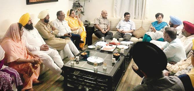 Kejriwal and Manish Sisodia with Punjab AAP MLAs during a meeting in New Delhi. Pic/PTI