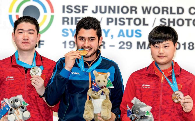 India shooter Anish Bhanwala (centre) with the gold after winning the 25m rapid fire pistol event at the ISSF Jr World Cup in Sydney yesterday