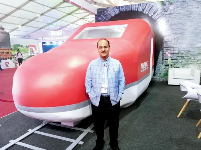 Aanchal Khare, NHSRCL chief, stands before a model of the future bullet train. file pic