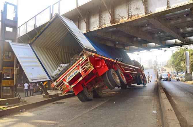 Central Railway authorities jumped into action after a truck got jammed under the bridge on March 6 and held up peak morning traffic for hours. Pic/Atul Kamble
