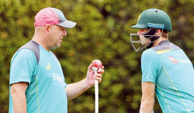 Oz coach Lehmann (left) chats with Steve Smith during a net session in Sydney earlier this year. Pic/AFP