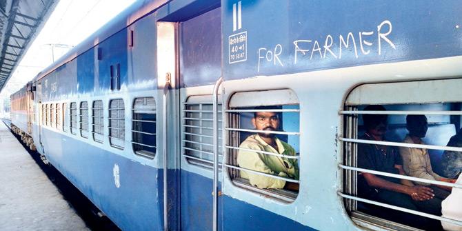 Farmers take the Panchavati Express, sitting in the additional coach attached to the train for them
