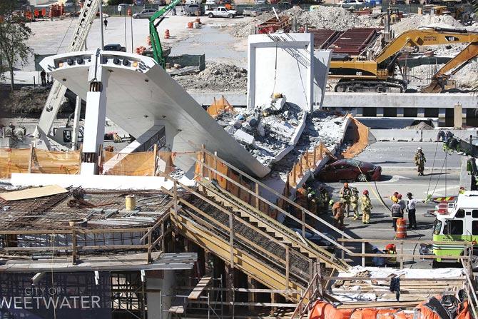 Miami-Dade Fire Rescue Department personel and other rescue units work at the scene where a pedestrian bridge collapsed a few days after it was built over southwest 8th street allowing people to bypass the busy street to reach Florida International University on March 15, 2018 in Miami, Florida. Reports indicate that there are an unknown number of fatalities as a result of the collapse, which crushed at least five cars. Pic/Getty Images/AFP