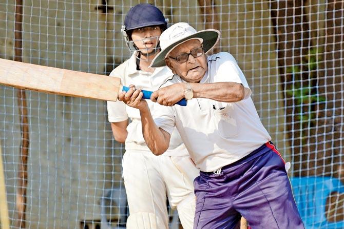 Veteran coach Hemant Hadkar shows a cricketer how to play a hook shot during a coaching session at Dadkar Maidan in Matunga. Hadkar was felicitated by his students on Wednesday.  PIC/SURESH KARKERA