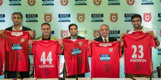 Kings XI Punjab mentor Virendra Sehwag and team captain R Ashwin unveil their team jersey for the Vivo IPL 2018. Pic/ PTI