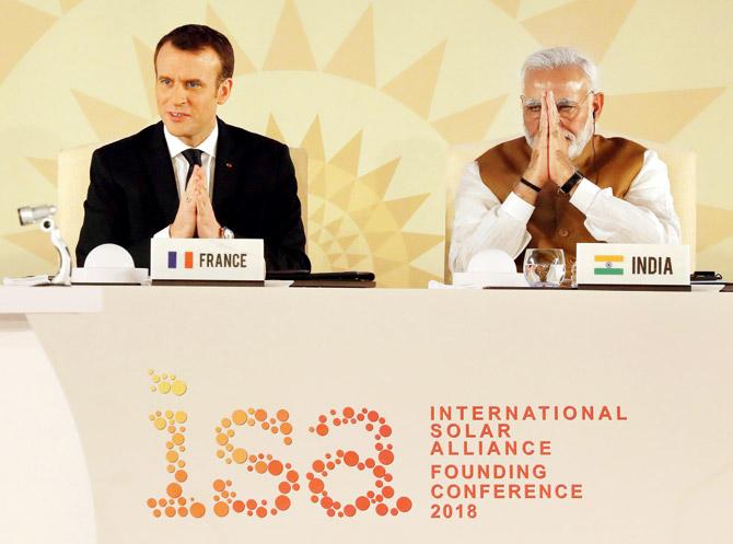 French President Emmanuel Macron and PM Narendra Modi attend the founding conference of ISA in New Delhi on Sunday. Pic/AFP