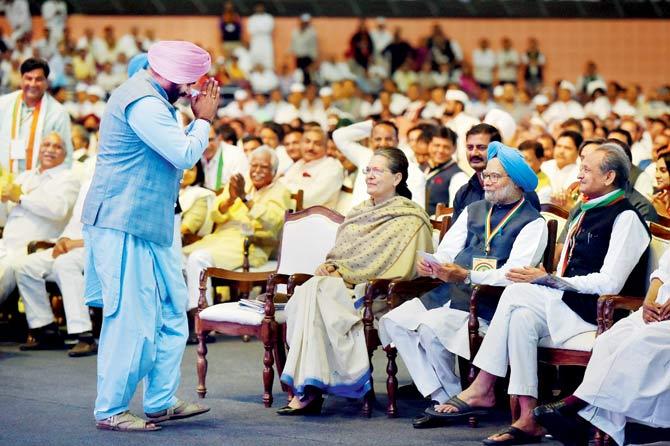 Punjab Tourism Minister Navjot Singh Sidhu greets former Congress President Sonia Gandhi during the second day of the 84th Congress Plenary Session, at the Indira Gandhi stadium in New Delhi. Pic/PTI