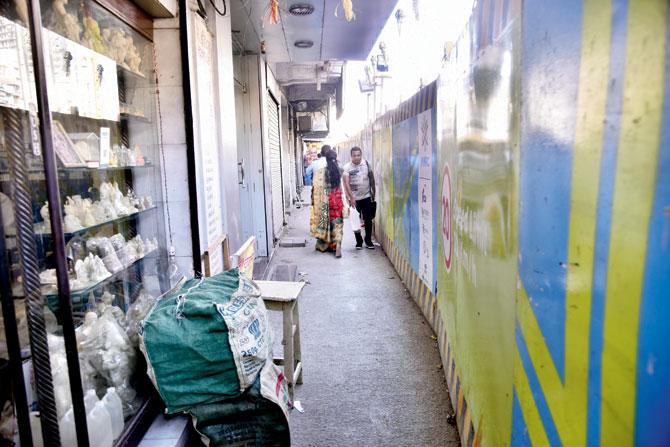 The tight corridor between the shops and the Metro barricade is hardly inviting to customers
