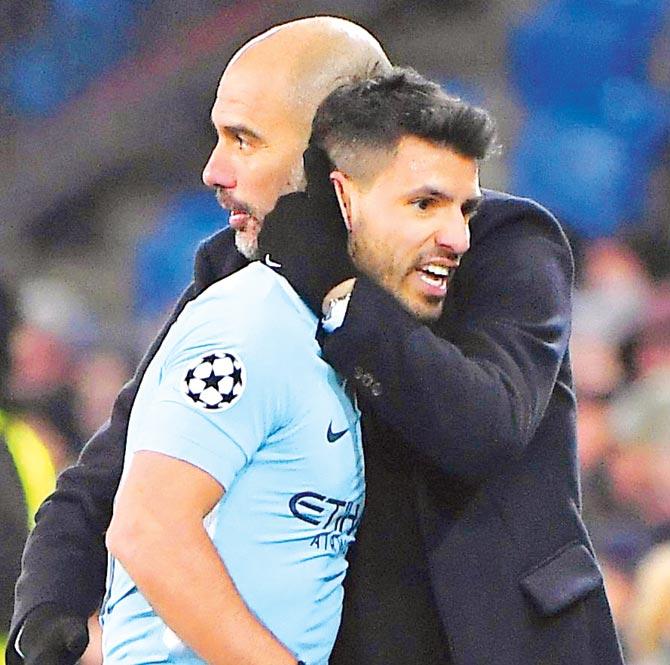 Man City boss Pep Guardiola (right) embraces striker Sergio Aguero during their Champions League tie against Basel last month. Pic/AFP