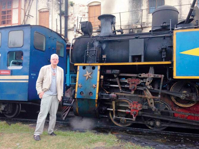 Author Christian Wolmar in front of a steam locomotive of the Nilgiri Mountain Railway during a visit to India