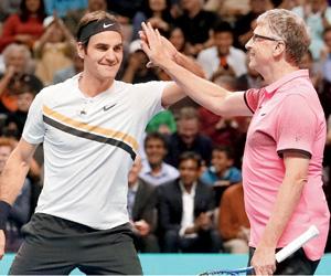 Roger Federer and Bill Gates play a tennis match for a cause