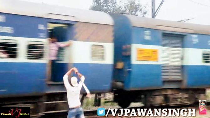 Screengrab of a video showing Pawan Singh trying to attack passengers of an express train with a hockey stick