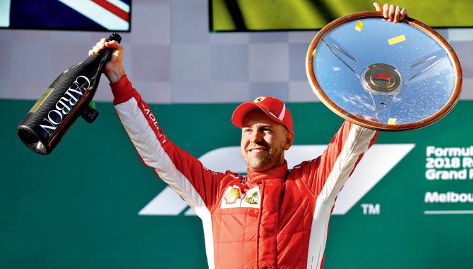 Ferrari driver Sebastian Vettel celebrates on the podium after winning the Australian GP in Melbourne yesterday. Pic/Getty Images