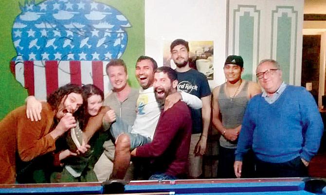 Vishnudas (centre, in white) celebrates his last day in San Jose, Costa Rica with people from the hostel he was volunteering at