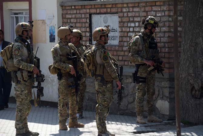 Afghan security personnel stand guard at the site of a suicide bombing attack in Kabul. Pic/ AFP