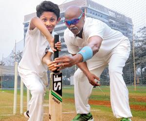 Vinod Kambli gives batting tips to his son, Jesus Christiano at MCA's BKC ground
