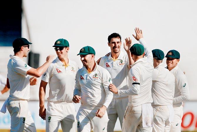 Australia’s Mitchell Starc (centre) celebrates the wicket of South Africa skipper Faf du Plessis with teammates in Durban yesterday. PIC/AFP