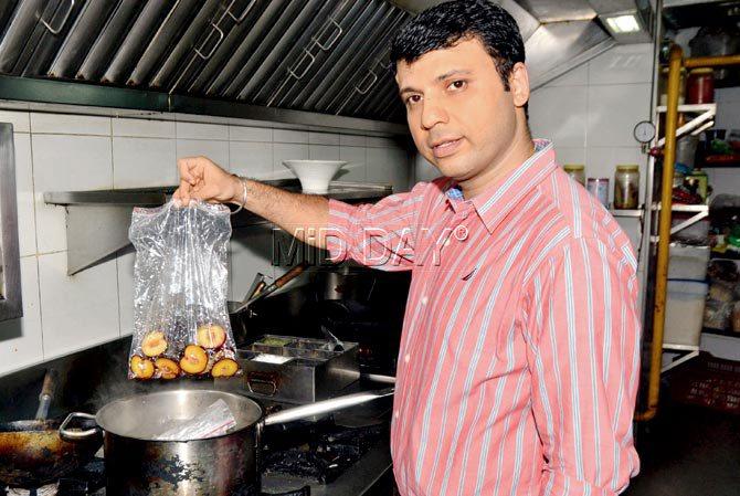 Chef Amit Bajaj sous-vide-ing plums