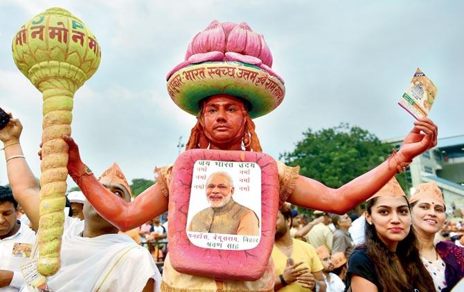 A BJP supporter during a public rally ahead of the elections. Pic/PTI