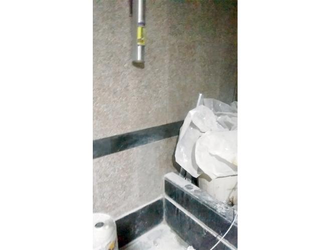 The water filter nozzle and the basin (right) Choked with bags carrying some white material, hiding the tap from view