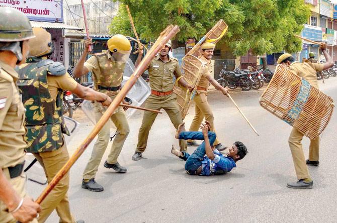 Police personnel baton charge at a protestor, in Tuticorin. Pic/PTI