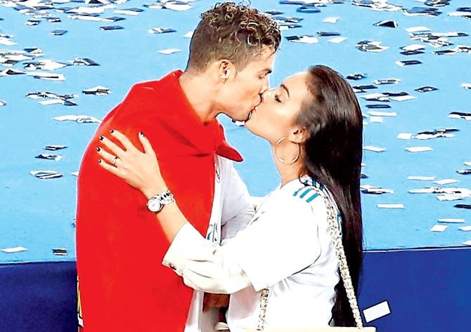 Real Madrid star striker Cristiano Ronaldo kisses girlfriend Georgina Rodriguez after winning the Champions League final on Saturday. Real Madrid beat Liverpool 3-1. Pic/AP, PTI