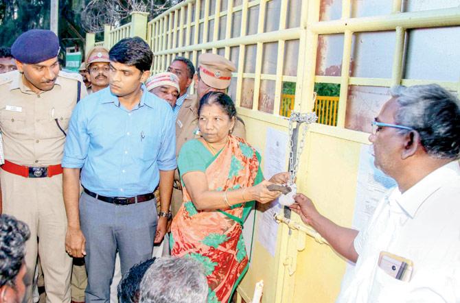 District Collector Sandeep Nanduri along with other officials seal the main gate of the Sterlite copper unit, on Monday. Pic/PTI