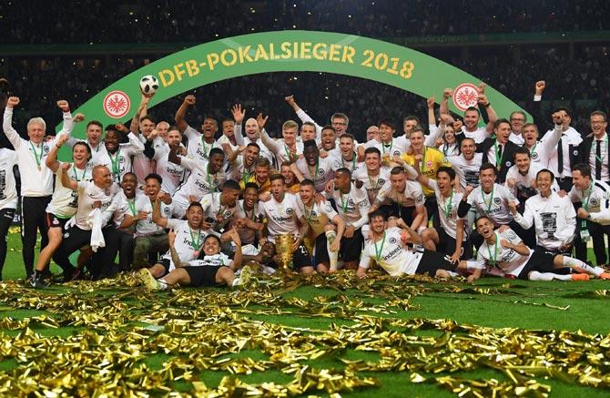 Eintracht Frankfurt players celebrate with the trophy after winning the German Cup DFB Pokal final soccer match between Bayern Munich and Eintracht Frankfurt at Olympiastadion in Berlin. Pic/AFP