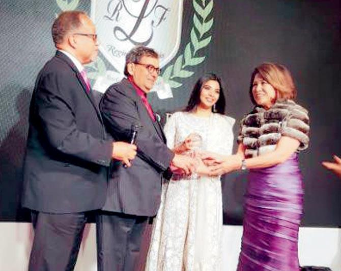 Ghai receiving the award