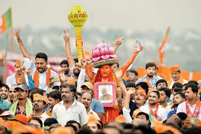 BJP supporters take part in a poll rally in Bengaluru, on Friday. Pic/AFP