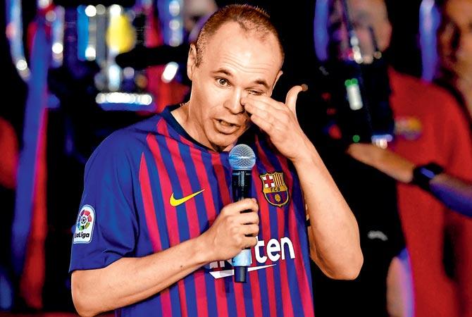 Andres Iniesta wipes his tears during a felicitation function where he bid farewell to Barcelona at Camp Nou. Pic/AFP