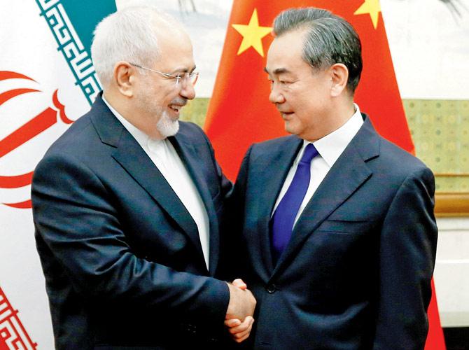 Chinese State Councillor Wang Yi meets Iranian Foreign Minister M Javad Zarif. Pic/AP/PTI