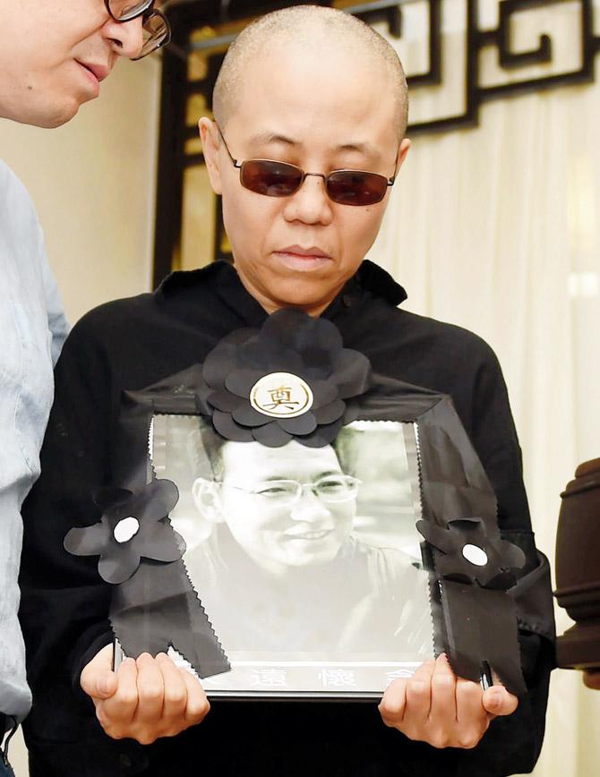 Liu Xia with a portrait of her husband Liu Xiaobo, a Chinese Nobel laureate. Pic/AFP