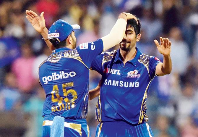 Mumbai pacer Jasprit Bumrah (right) is congratulated by his skipper Rohit Sharma during their T20 2018 match against Punjab at the Wankhede Stadium on Wednesday. Pic/Suresh Karkera